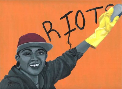 A young man in a cap reaching up with a yellow-gloved hand to write the word RIOTS on an orange wall
