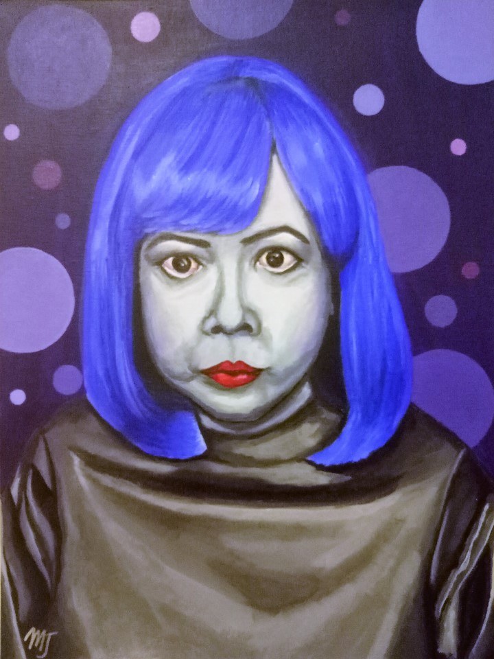 A woman in a bright purple bob wig looking straight out, surrounded by purple polka dots on a dark ground
